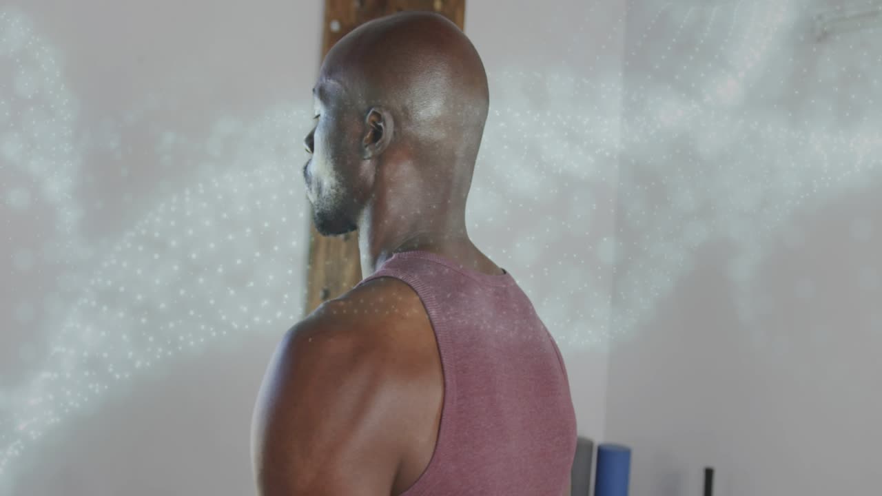 Man turning to cam, welcoming fitness audience as cam closing in, particles sweeping past man