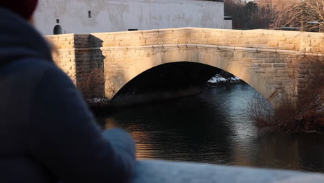 winter sunset over a stone arch bridge