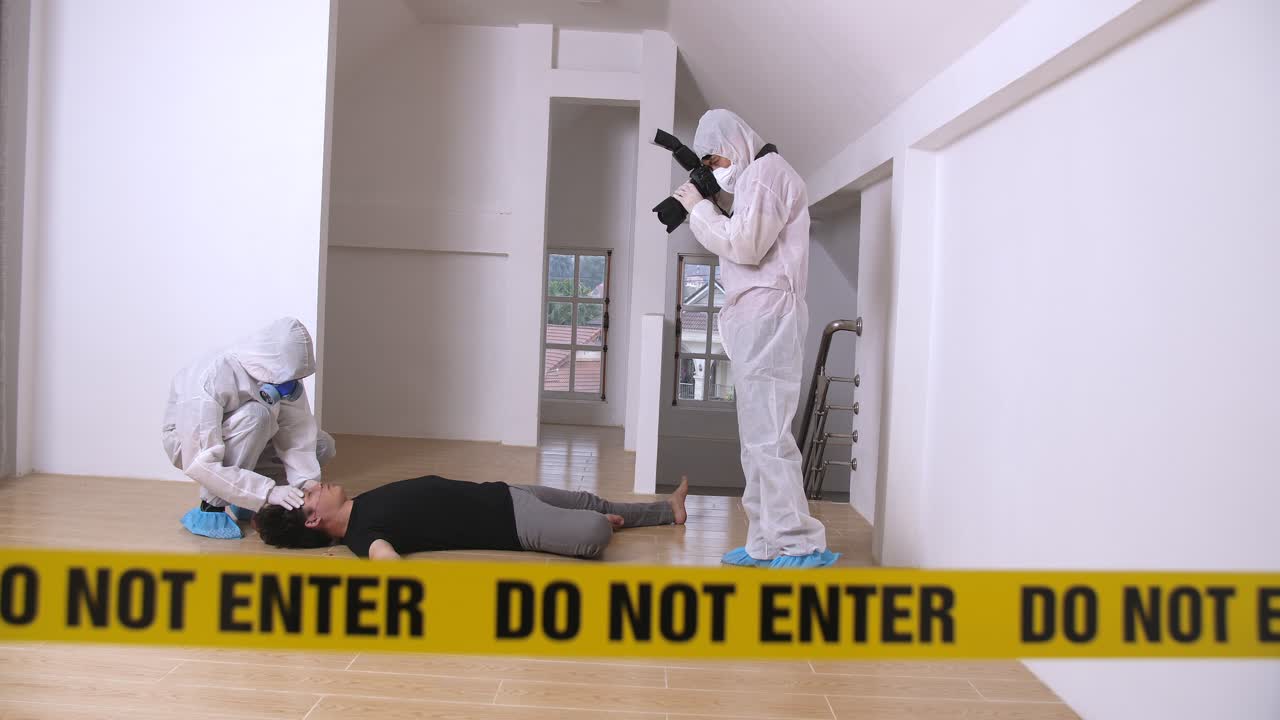 Criminologist Expert Collecting Evidence At The Crime Scene