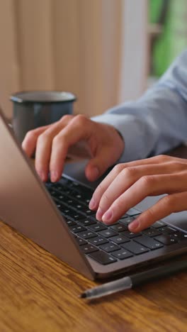 person typing on a laptop