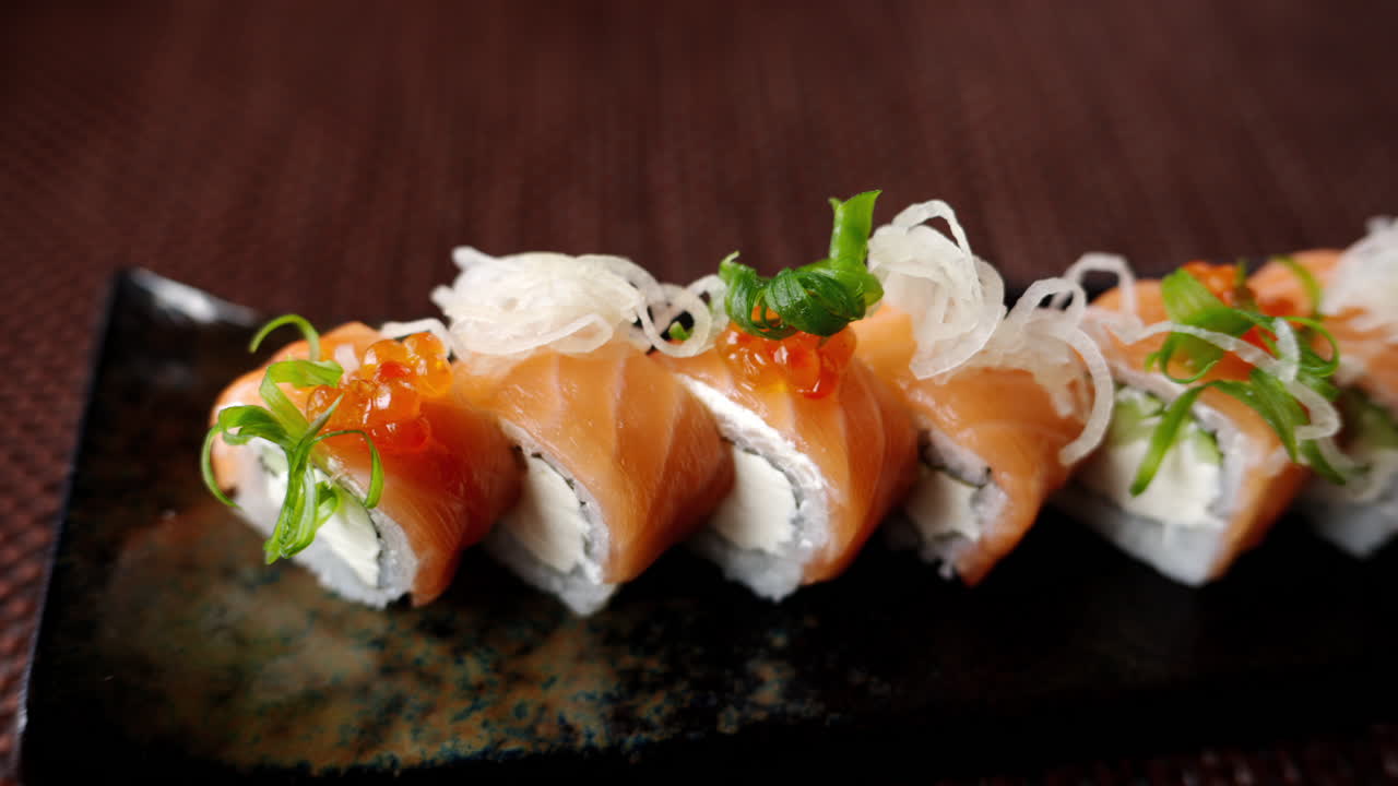 Close up of a Philadelphia sushi roll on a table at a restaurant