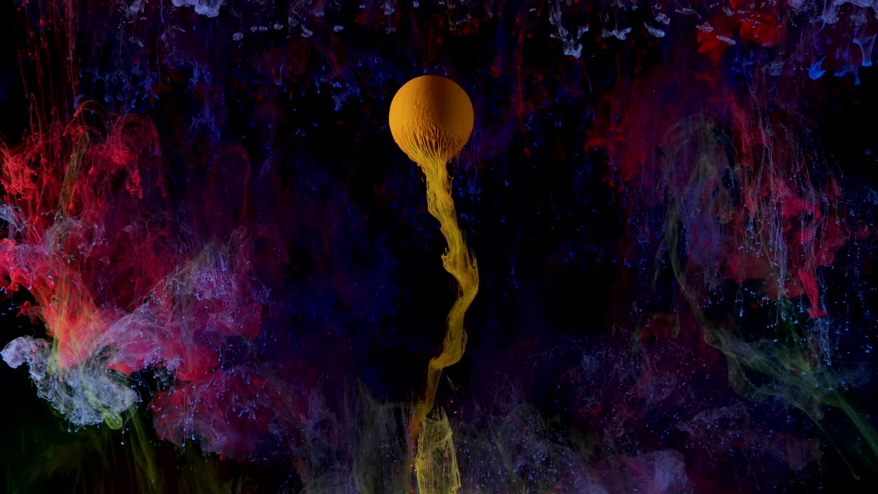 Multicolored ink paint slowly flows from the ball