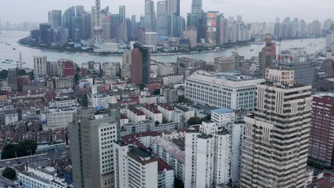 shanghai business district reveal from downtown city suburb, aerial view