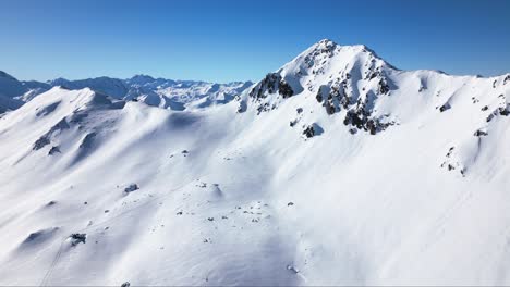 a-beautiful-white-winter-landscape-with-endless-big-mountains,-a-blue-sky-and-a-wide-horizon