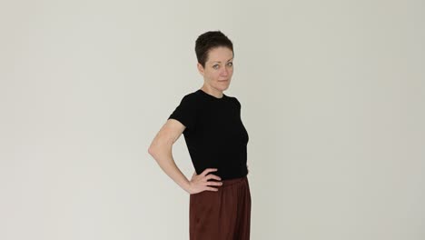 portrait of a woman with short hair in a black t-shirt and brown pants