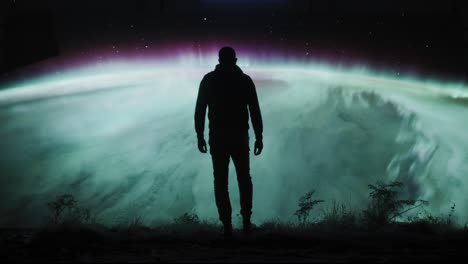 man contemplating the aurora borealis