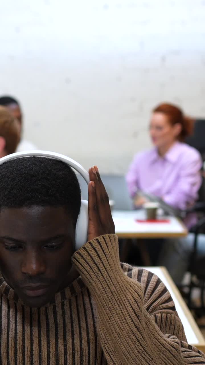 People using headphones in an office setting