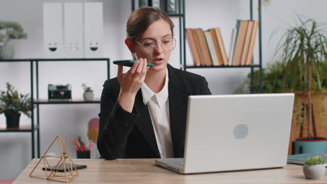 young business woman working, have mobile phone talk at office workplace using messenger chat apps