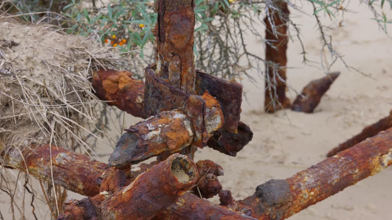 Old rusting and corroded scaffold poles, used as sea defenses and to stop coastal erosion on the east coast of the UK