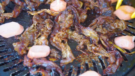 close up shot of cooking barbeque meat and sausage on grill pan