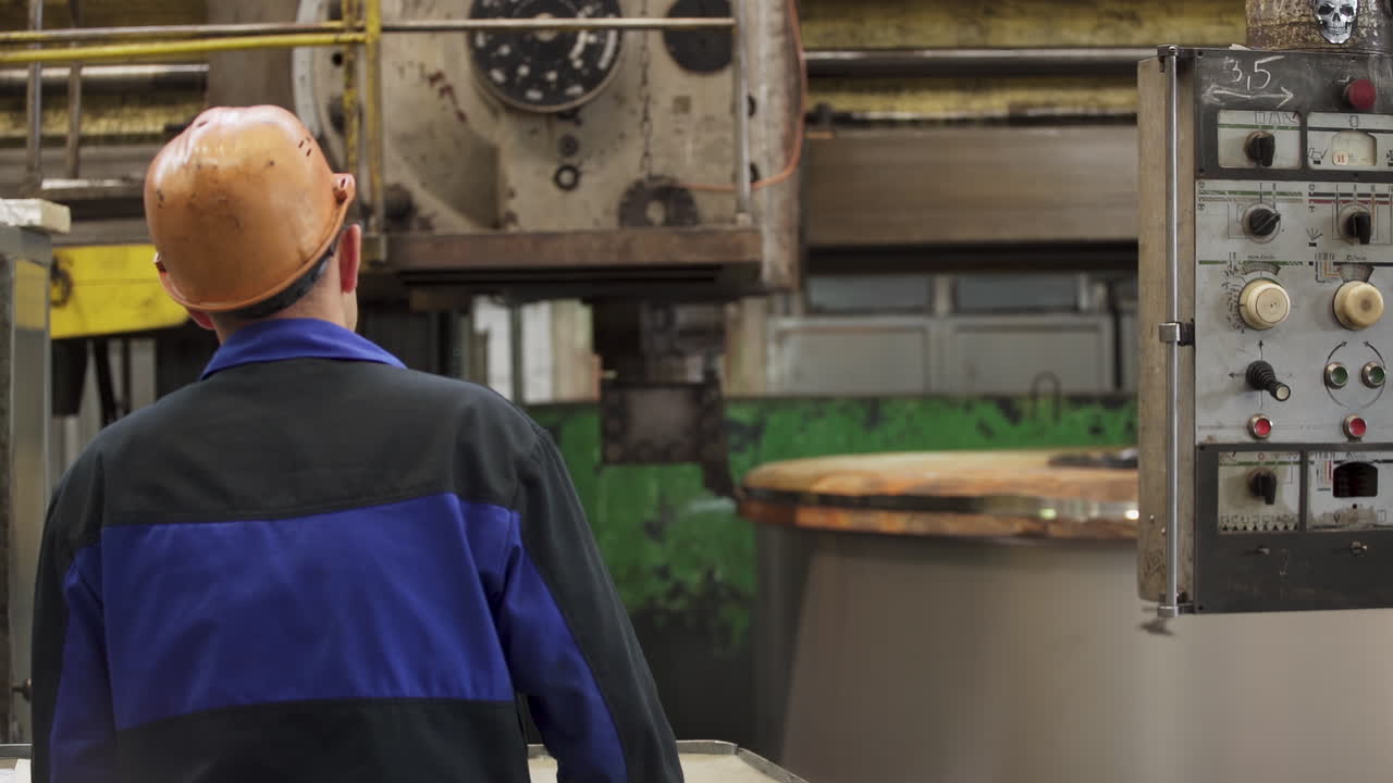 Factory worker observing machinery