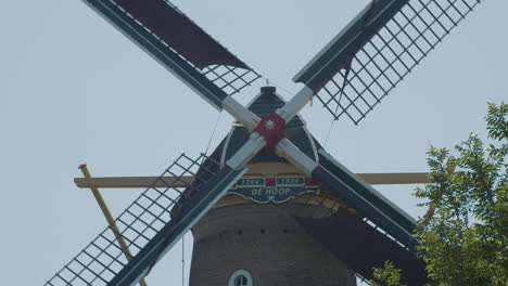 close up of old dutch windmill wing cross spinning