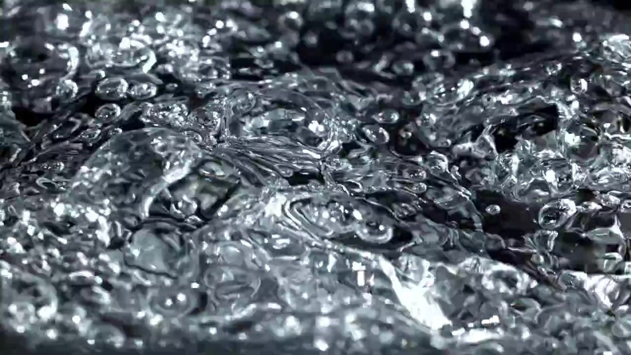 Macro di acqua limpida che gorgoglia su sfondo scuro