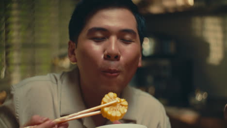 man eating rice with chopsticks