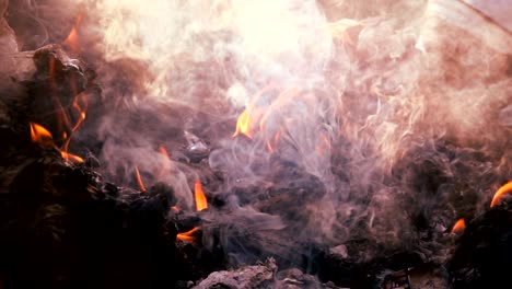 slow motion fire burning garbage bag on sunrise dark backgorund. white smoke floating to air pollution and dangerous environment. garbage is waste from comunity. it make green house effect of earth.