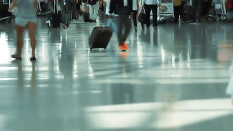 people walking through a busy airport terminal