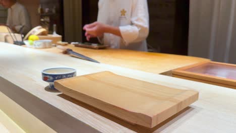 chef skillfully prepares sushi at a counter