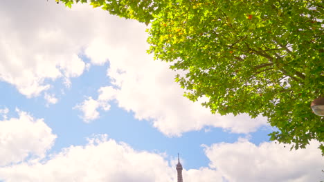 panning down at eiffel tower across the river in summer 4k paris, france