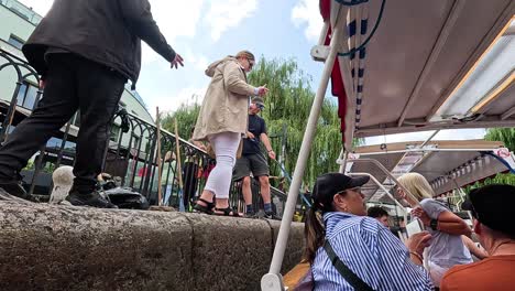 people boarding a narrowboat in camden town