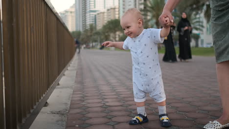 laughing boy at the age of 1 year dancing.