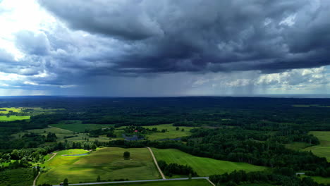 poderosas nubes de lluvia oscura derramando agua sobre los campos agrícolas, vista aérea