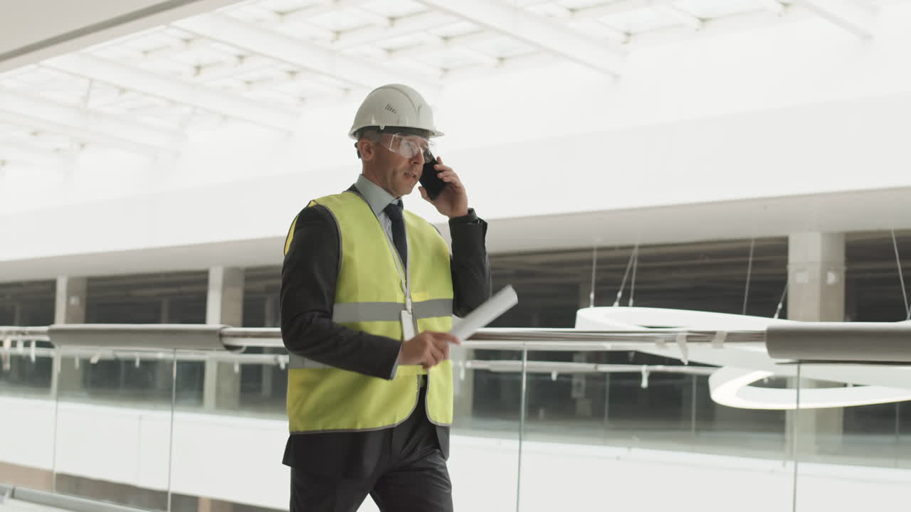 Architect Talking on Cellphone Walking