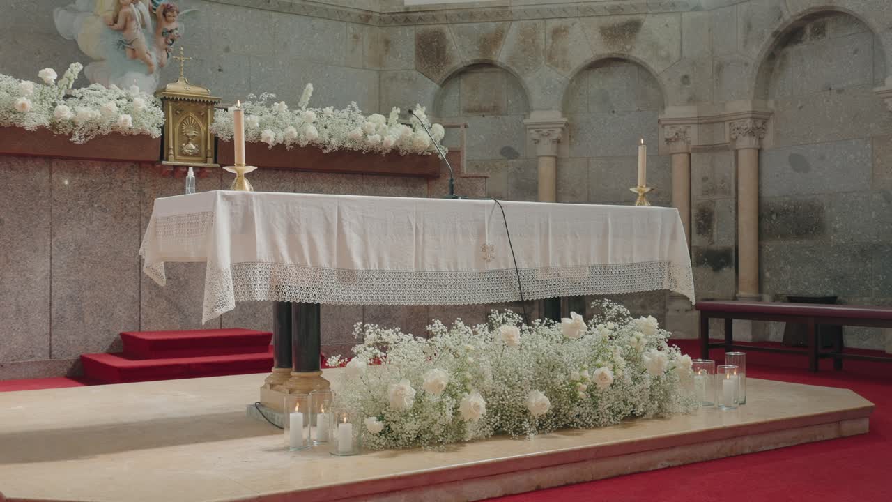 Elegant wedding altar with floral arrangements and candles in church