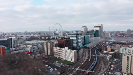 slow dolly forward drone shot towards london eye over waterloo train station