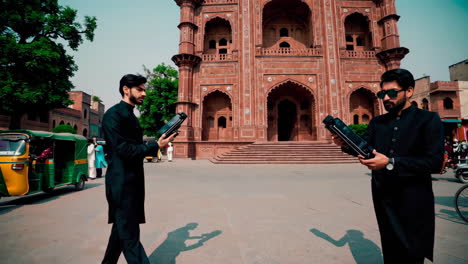 men in traditional pakistani clothing in a city market