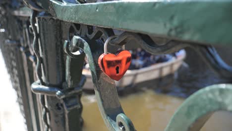 a heart shaped lock on a bridge.