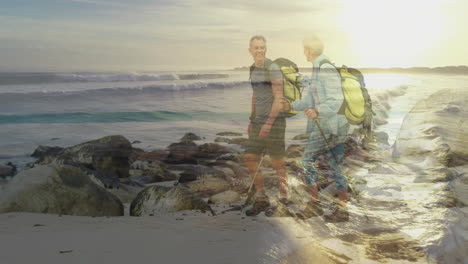 senior hikers walking rocky beach at sunset, with animated health graph and wave icons