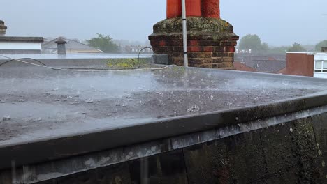 heavy rain downpour on a flat residential roof