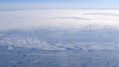 frozen arctic sea seen from the flying airplane, sunny day