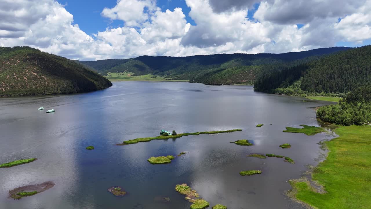 Breathtaking aerial footage of the alpine Shudu Lake surrounded by lush forests and mountains in ShangriLa, Yunnan Province. Ideal for travel documentaries and nature content