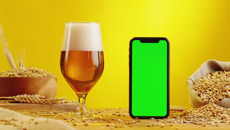 beer and mobile phone with green screen