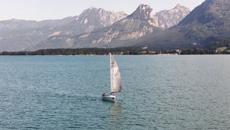 sailboat on a lake in the alps
