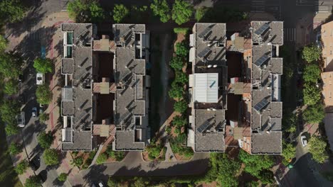 top-down drone view revealing modern housing blocks surrounded by greenery in málaga, spain