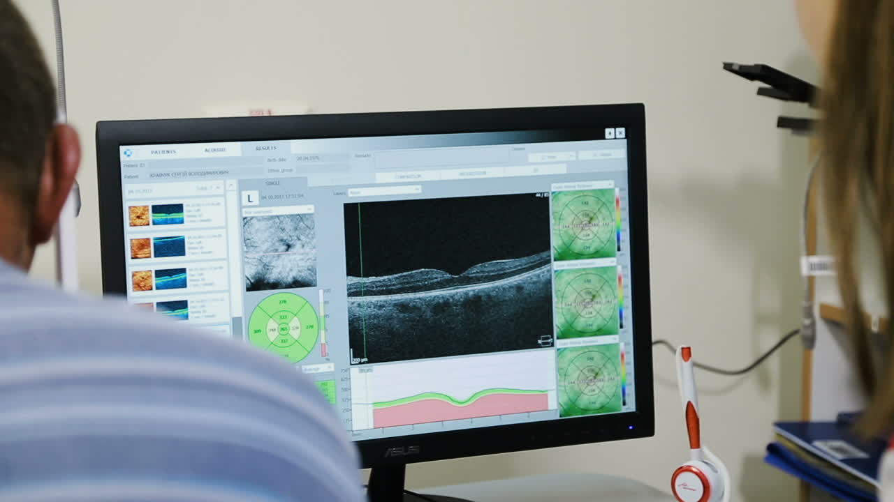 Man having eye test. Female optometrist examining mans eyes through slit lamp in clinic