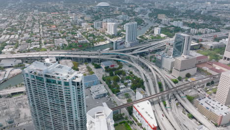 Fly-above-modern-urban-borough.-High-angle-view-of-busy-highway-interchange.-Individual-transport-and-infrastructure-traffic.-Miami,-USA