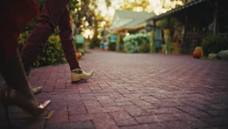 couple walking on a cobblestone street