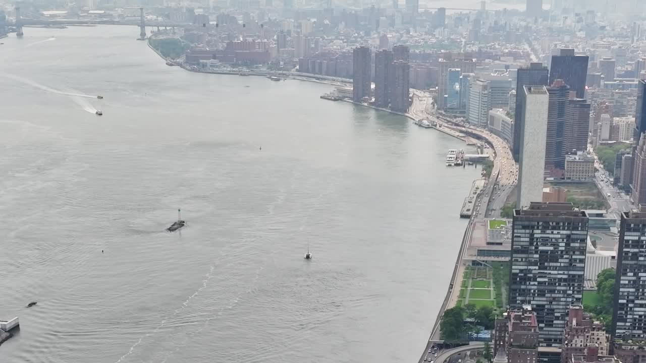 Expansive aerial view of New York City along the river and skyline