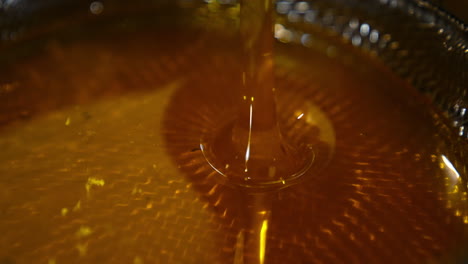 honey pouring into a bowl