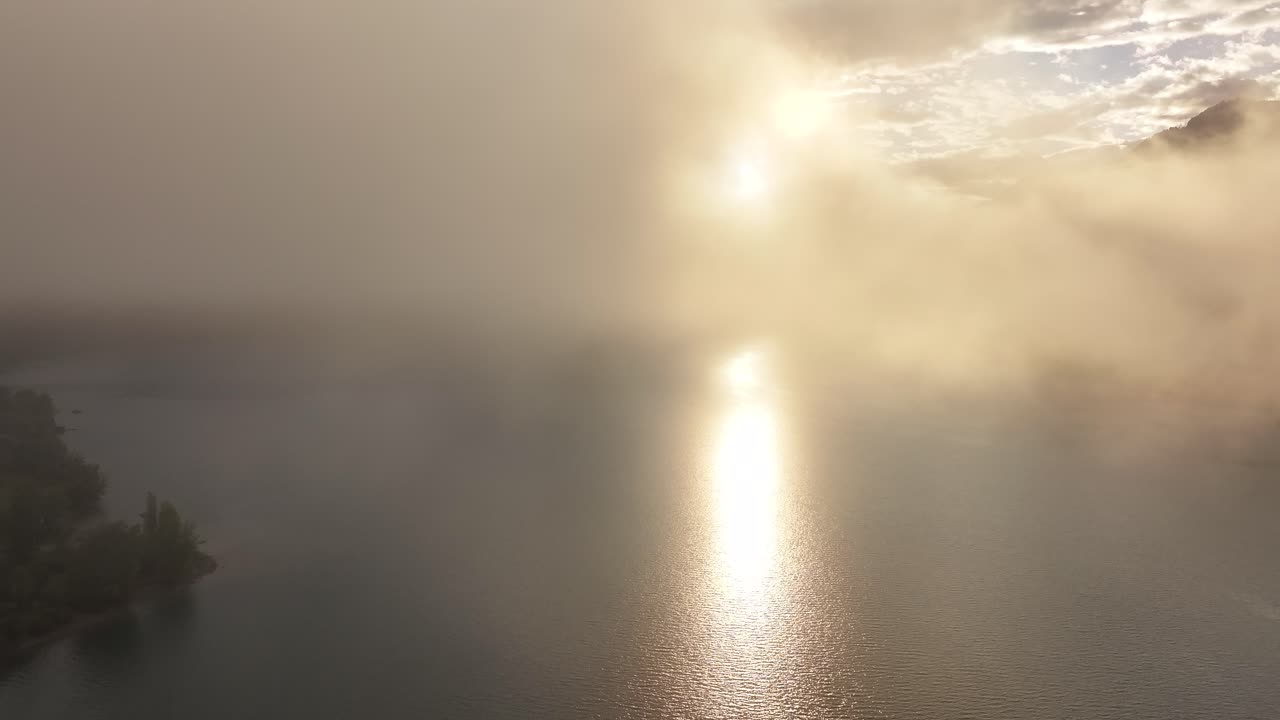 Sunset over a foggy lake in the mountains