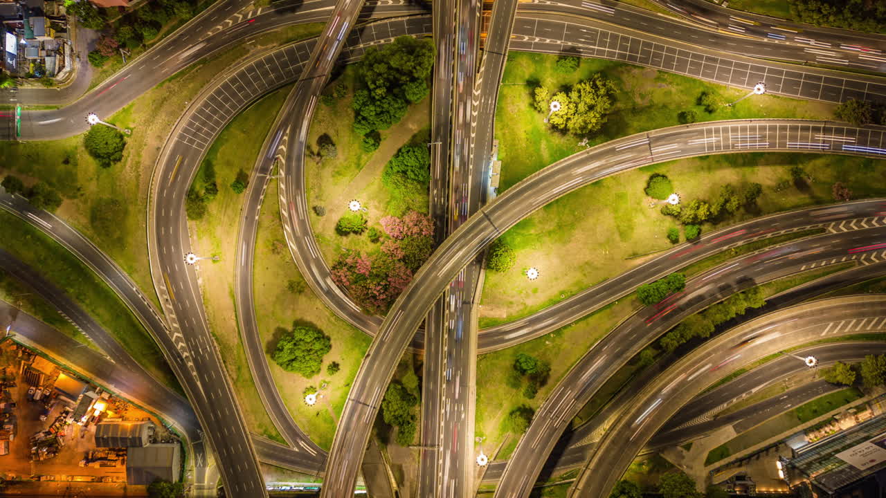 Aerial Time Lapse of Busy Highway Interchange at Night with Light Trails