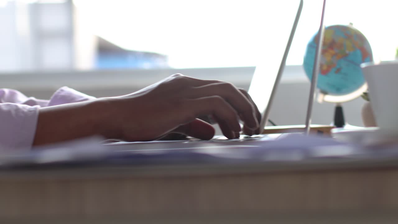 Hand of businessman typing on laptop keyboard in the office