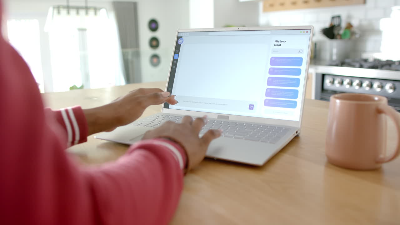 African American woman typing on laptop, showing Ai Chat Bot Screen, at home