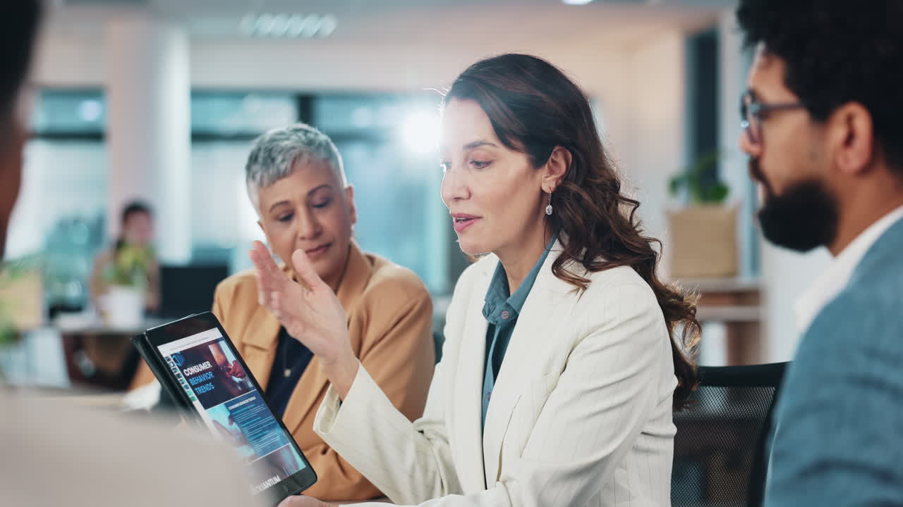 Business woman giving a presentation to her team in a meeting