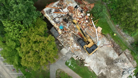 aerial view of building demolition with excavator