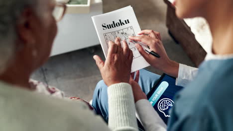 senior citizen playing sudoku with caregiver