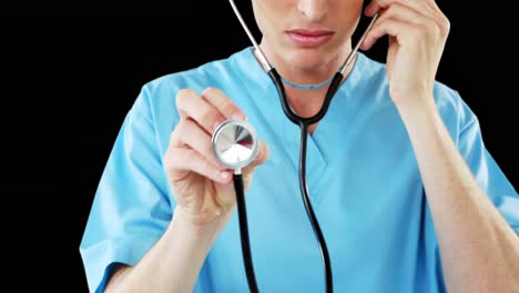 Close-up-of-male-surgeon-checking-with-stethoscope